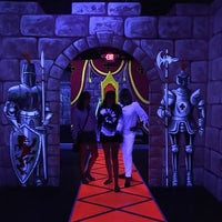 Photo taken at Dragon&amp;#39;s Lair Blacklight Indoor Golf by Kate P. on 7/26/2017