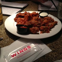Photo taken at Wings Tap &amp; Grill by Bosco A. on 10/13/2012