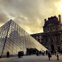 Photo taken at Louvre Pyramid by Mont W. on 12/18/2012