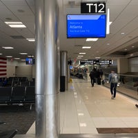 Photo taken at Gate T12 by Roberto R. on 2/28/2020