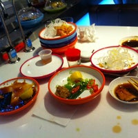 Photo taken at YO! Sushi by Andrea D. on 7/13/2012