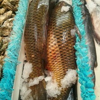 Photo taken at Tambuli Seafood Market by Mel J. on 11/29/2012