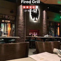 Photo taken at Firebirds Wood Fired Grill by Ethan H. on 11/20/2018