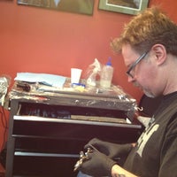 Photo taken at Slave to the Needle Tattoo by Sirena M. on 12/21/2012