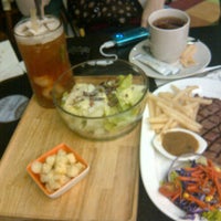Photo taken at Opus Cafe by Dewi Y. on 4/14/2012