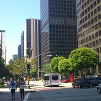 Photo taken at Bus Stop 5th St &amp;amp; Flower St by Shaun C. on 7/24/2013