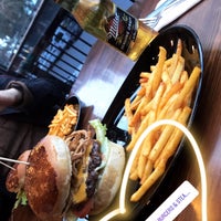 Photo taken at Holy Cow Gourmet Burgers &amp;amp; Steakhouse by Gülce C. on 3/4/2018
