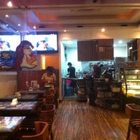 Photo taken at Buzz Cafe by Manu on 1/1/2012