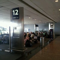 Photo taken at Gate 12 by Cristian B. on 11/7/2012