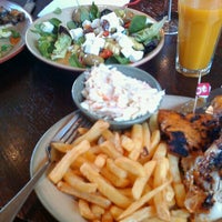 Photo taken at Nando&amp;#39;s by Andris S. on 8/4/2012
