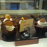 Photo taken at Indulge Cupcake Boutique by Tria W. on 12/18/2011