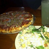 Photo taken at Red West Pizza by Daisy T. on 3/13/2012
