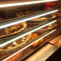 Photo taken at Justino&amp;#39;s Pizzeria by Shawn G. on 8/11/2011