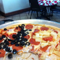 Photo taken at Carmine&amp;#39;s Pizzeria by Georgina T. on 9/1/2012