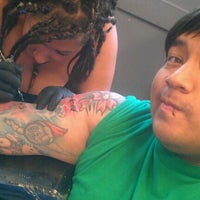 Photo taken at Coy Fish Tattoo by Tony Z. on 7/4/2012