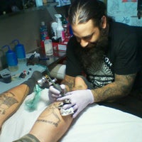 Photo taken at Revolution Tattoo by Amy J. on 8/5/2012
