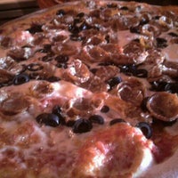 Photo taken at Brick Oven on 35th by Nellie J. on 7/25/2011