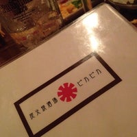 Photo taken at 炭火焼酒場 ピカピカ by yasu on 6/15/2012