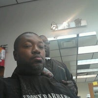 Photo taken at Ebony Barbers Unisex by Micah M. on 7/27/2012