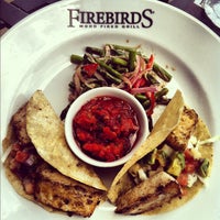 Photo taken at Firebirds Wood Fired Grill by Lisa S. on 7/28/2012