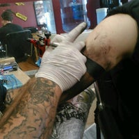 Photo taken at Into Pain Tattoo by Colin T. on 6/29/2012