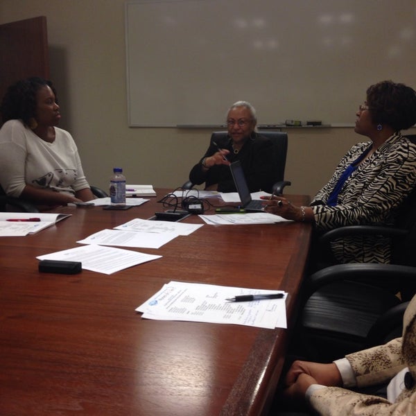 Faculty discuss how to best allocate resources in the Millgan Building tutor office.