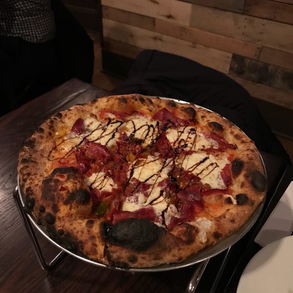 Photo taken at Dough Artisan Pizzeria by Annie P. on 4/6/2018