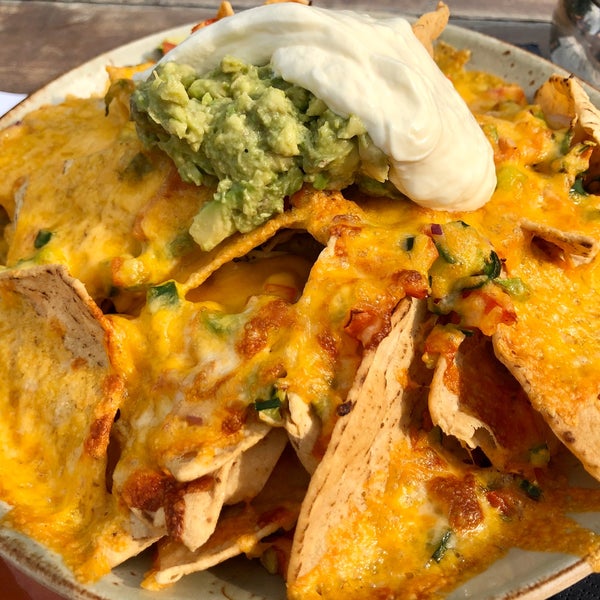 Just had these delectable #nachos, which were surprisingly served with chopped cucumber and jalapeño, in between the layers of melted cheese.  Super crispy.  😋 #californiagirl #mexicanfood