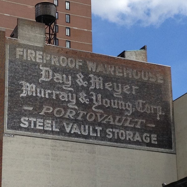 One of the biggest I have seen and about to disappear because of a new building going up.  Sign reads: Fireproof warehouse | Day & Meyer | Murray & Young Corp | - Portovault - | Steel Vault Storage.