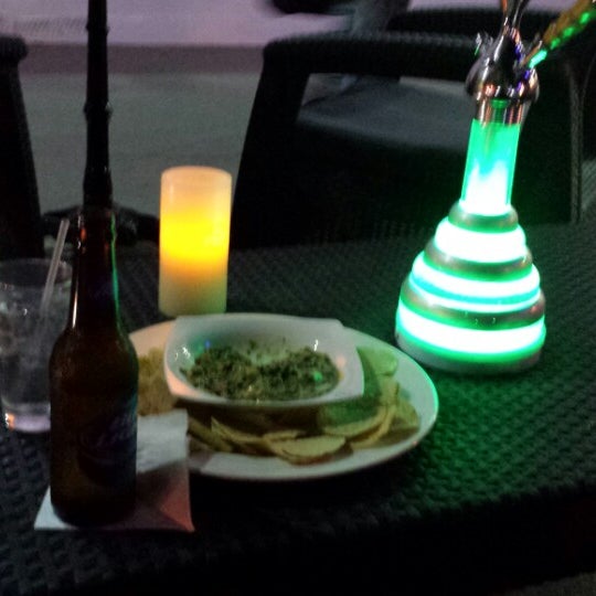 Photo taken at Deco Drive Cigars and Hookah Lounge by Maurice R. on 3/16/2014