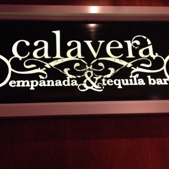 Photo taken at Calavera Empanadas &amp; Tequila Bar by Rachel A. on 11/21/2012