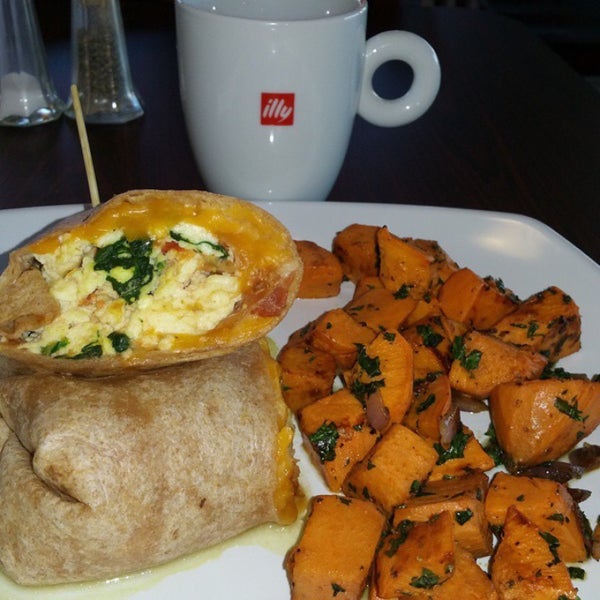 Sooo good. Breakfast burrito with your choice of egg w/lean bacon, tomato and spinach wrapped in a whole wheat tortilla. I got a side of extra sweet potato hash sauté with kale and red onion!
