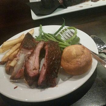 Baby back ribs with green beans, corn bread and fries