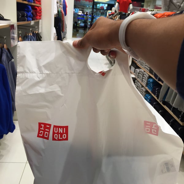 Uniqlo red Tshirt displayed packed in plastic bag closeup Stock Photo   Alamy