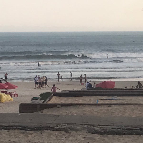Photo taken at Praia da Joaquina by Fernando J. on 11/21/2019