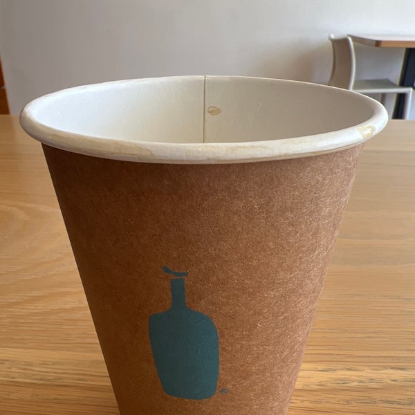 A photo that includes coffee cup, cup, and wood from Blue Bottle