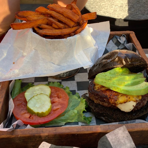 Order the Caribe (beef patty, white cheese, sweet plantain, avocado & their signature honey ginger tarragon sauce). You can opt for a charcoal activated bun at no additional cost.