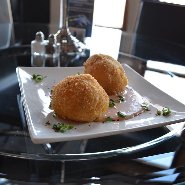 Enjoy our Fried Bacon & Jalapeno Mac-n-Cheese Balls with Remoulade Sauce for FREE..$9 value..with the purchase of TWO Martini's!