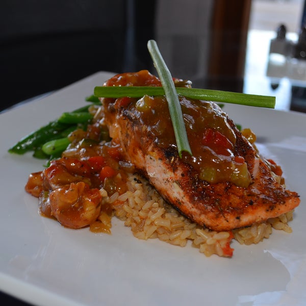 Treat yourself to Blackened Salmon with Crayfish Ragout & Cajun Rice $19...tastes even better than it looks!
