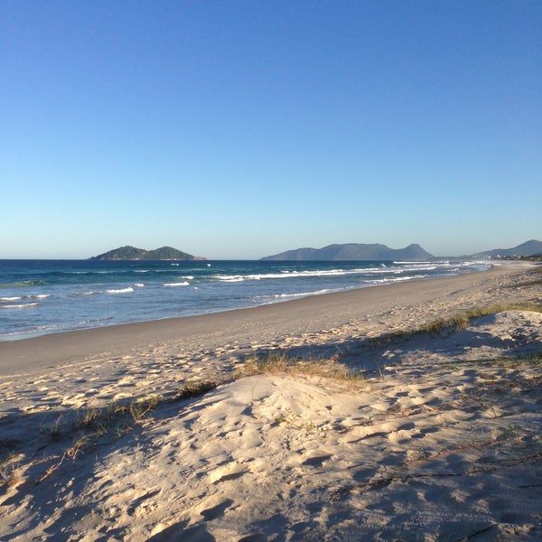 Photo taken at Praia da Joaquina by Dimitri D. on 5/10/2013