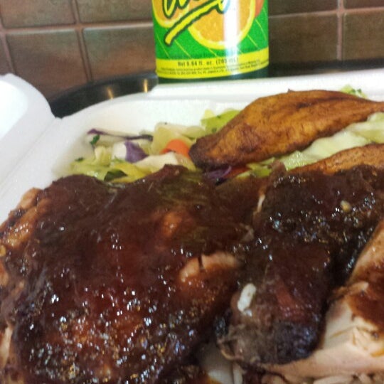 Photo taken at Jerk Hut Jamaican Grille by Mark T. on 3/21/2014