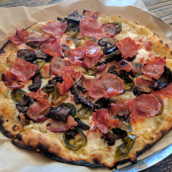 Call it The Cowboy- rosemary goat cheese, marinara, candied jalapenos, red wine baby bellas, apple wood smoked bacon, and calabrese.  You'll never want to eat another pizza.
