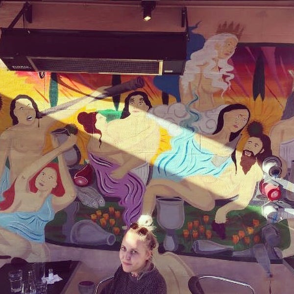 Enjoy the food outdoors next to our colorful mural.