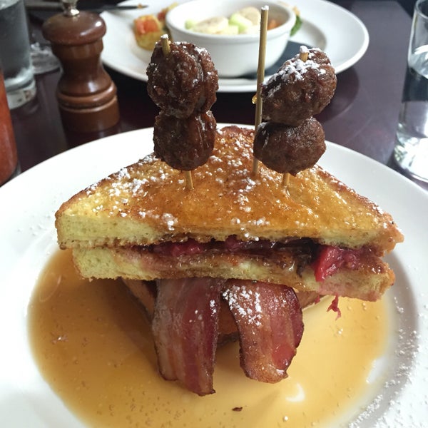 Custer's Last Stack - French toast sandwich with peanut butter, caramel, banana, nutella and strawberries! Cannot go wrong with the layered thick cut applewood smoked bacon and chorizo on the top. Mmm