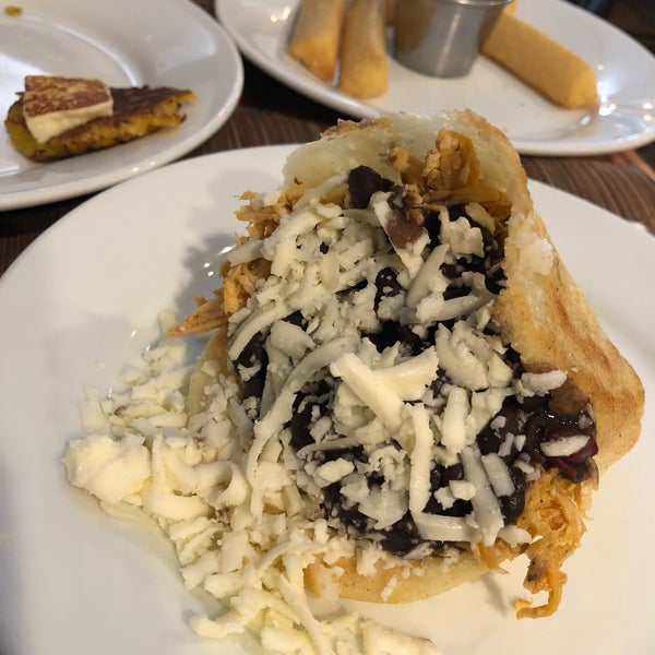 Photo taken at Arepas Cafe by Maria S. on 5/6/2018
