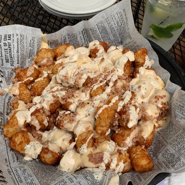Loaded tater tots - cheese sauce, bacon, Cajun sour cream, and (no) green onions. #mollys #24hourfoodgeek Follow us at http://24hourfoodgeek.com