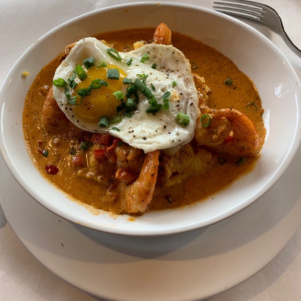 Shrimp & grits - sautéed shrimp, creole sauce, and cheddar grits topped with a sunny side up egg. #Bricktops #24hourfoodgeek Follow us at http://24hourfoodgeek.wordpress.com