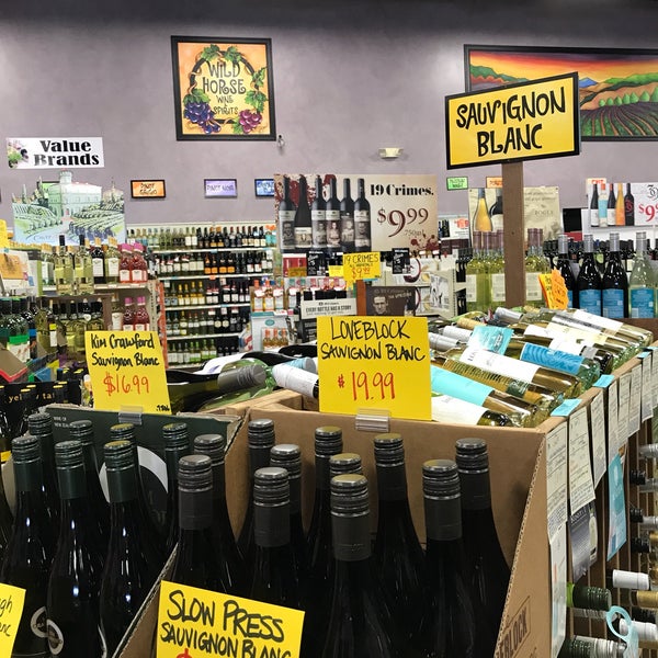 Photo taken at Wild Horse Wine &amp; Spirits by Marie F. on 3/30/2018