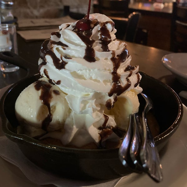 CHOCOLATE CHIP COOKIE SKILLET SUNDAE (A GIANT CHOCOLATE CHIP COOKIE SERVED WARM WITH VANILLA ICE CREAM, CHOCOLATE SYRUP & WHIPPED CREAM)