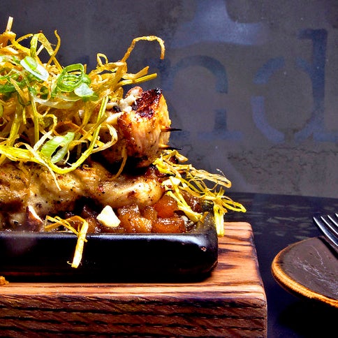 The beef tartare melds Korean raw-beef dish yuk hwe, Sichuan peppercorns, French bone-marrow paste, Vietnamese herbs and Indonesian-style cassava chips.